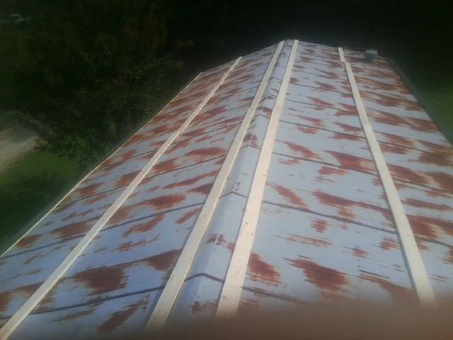 Rusted metal roof panels with new wood purlins before replacement — Storm Damage Roof Repair in Hampshire by Roofing Brothers