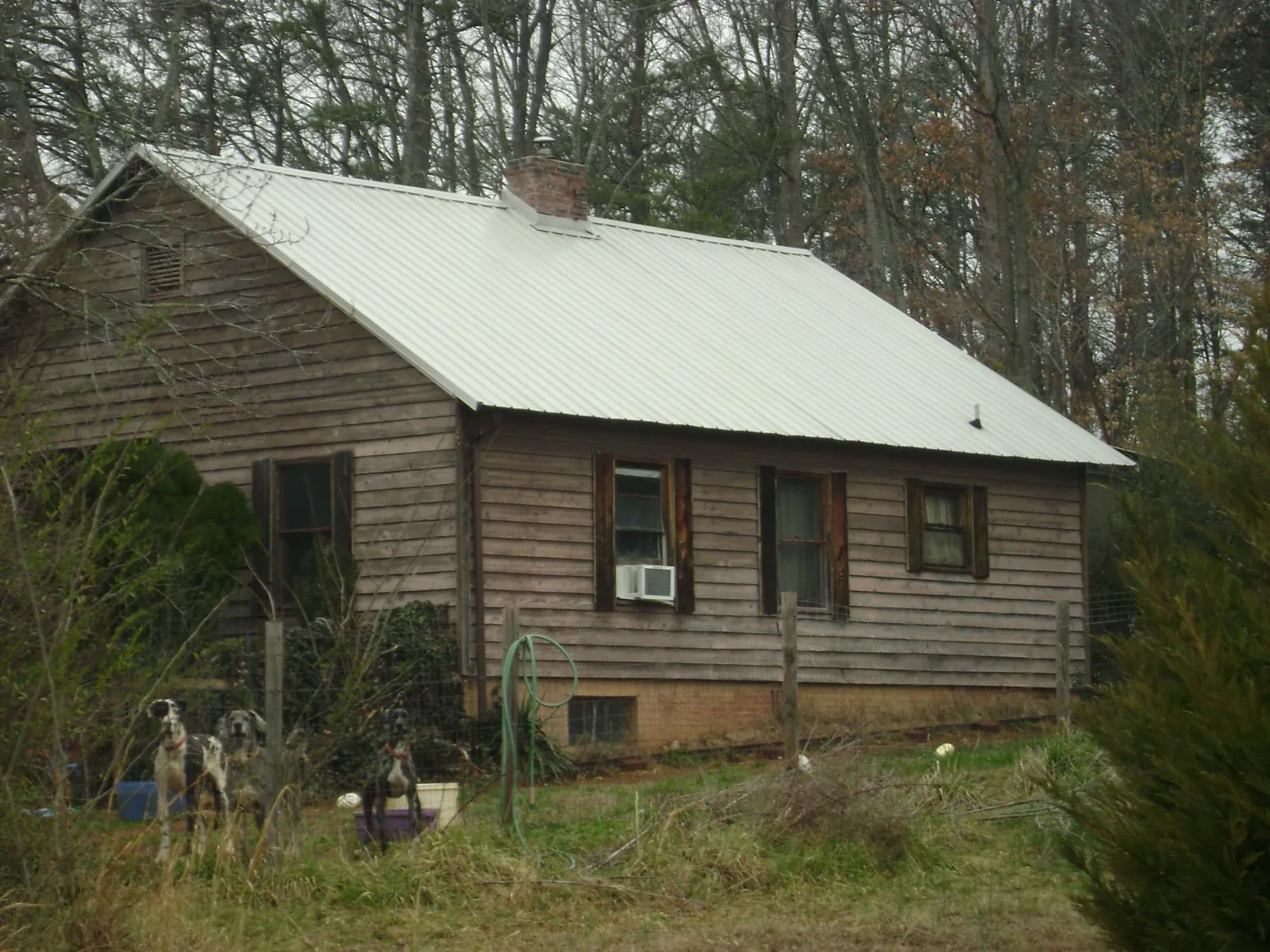 White metal roof on an old wood sided farmhouse, from a Metal Roof Installation job in Hampshire